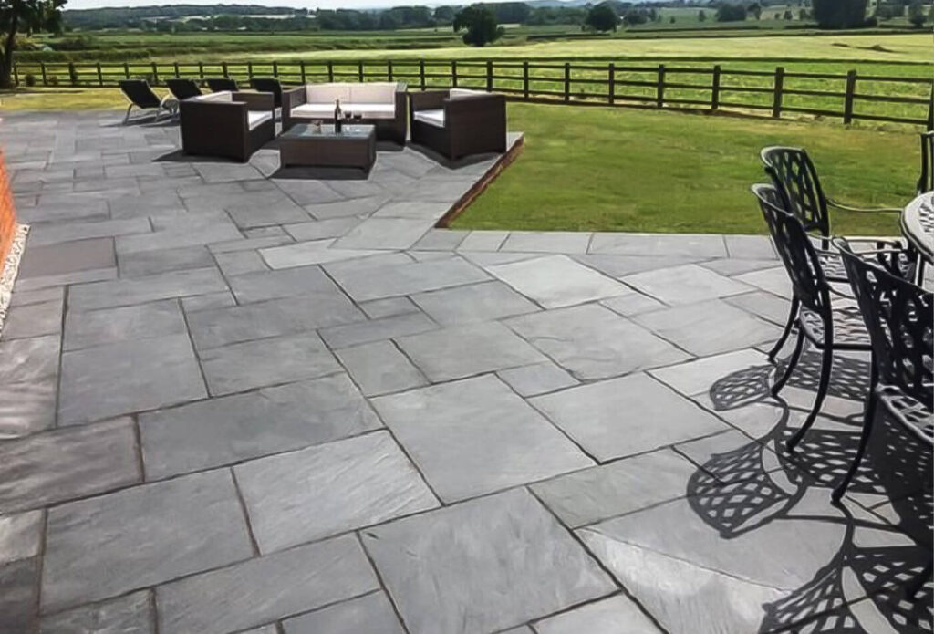 A structural concrete slab foundation for a home addition, showing a 6-mil vapor barrier and reinforced rebar grid compliant with Johns Creek building codes.